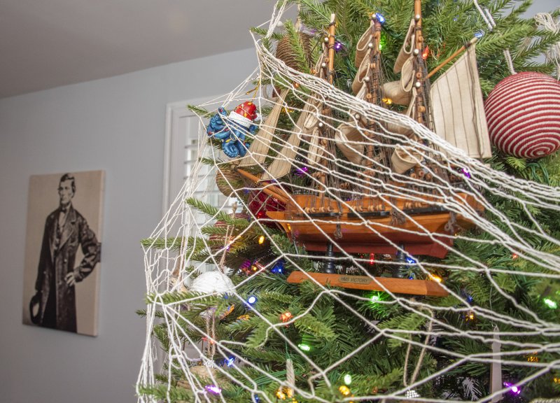 In the kitchen of Peggy and Ed Duckworth’s Mulberry Street home is a shipbuilding-themed tree with a portrait of shipbuilder C.C. Davidson watching from the shadows.